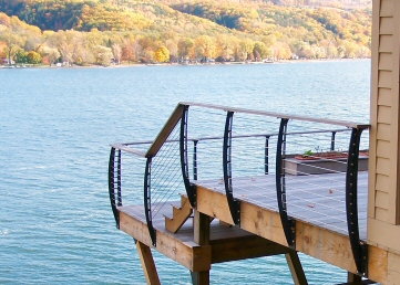 Outdoor deck with thin horizontal cables spanning curved black posts